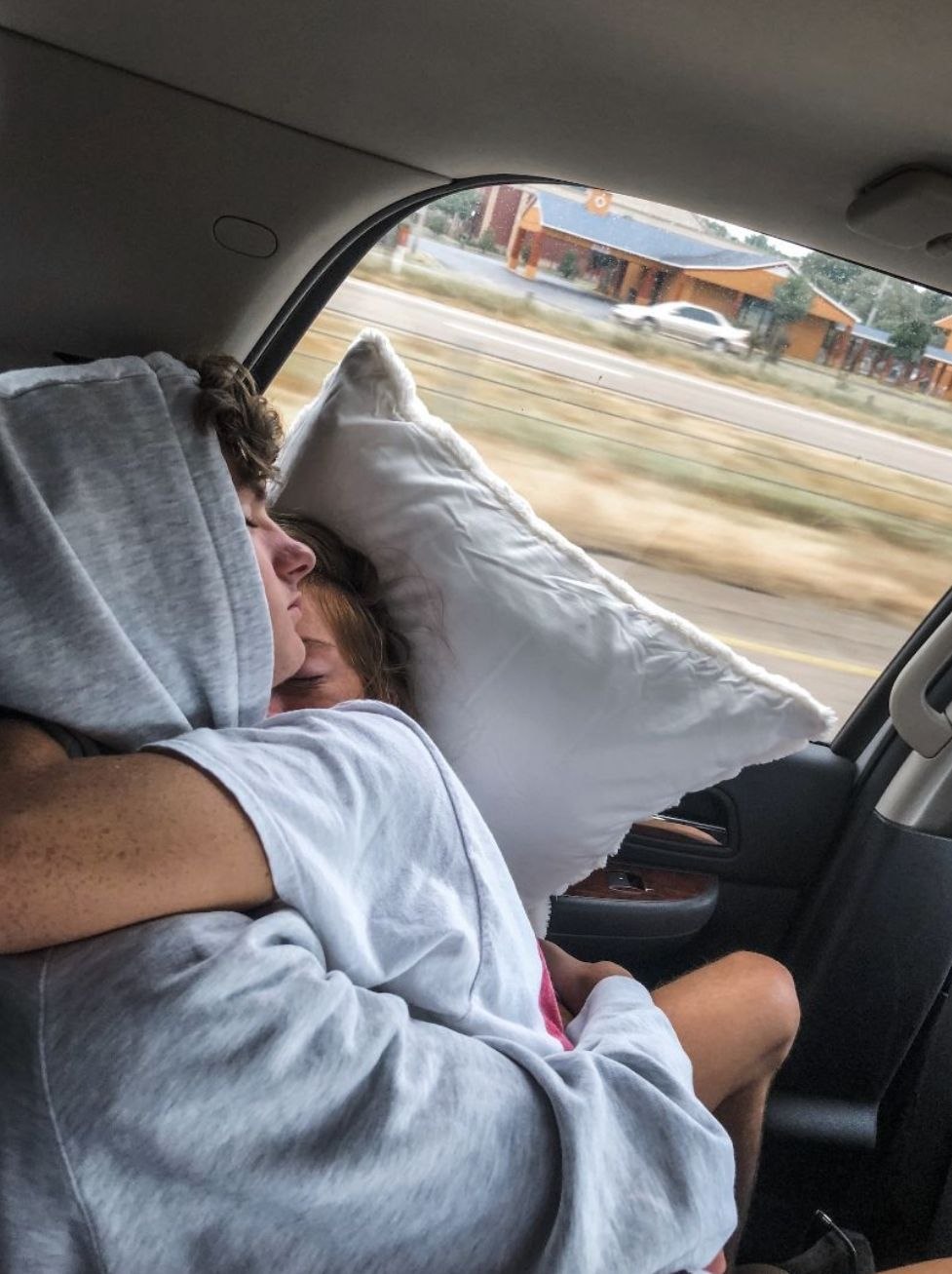 The guy is sleeping in the car