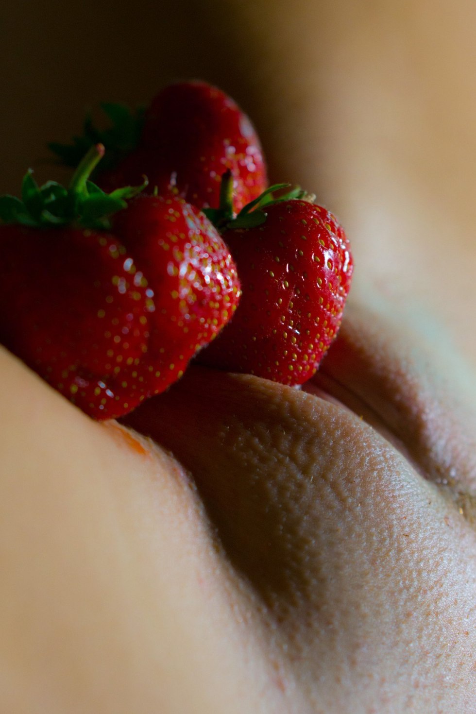Erotic photo with strawberry