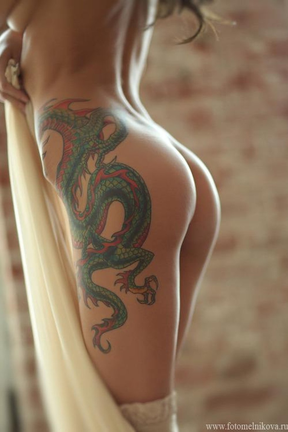 Porn actress with a dragon tattoo