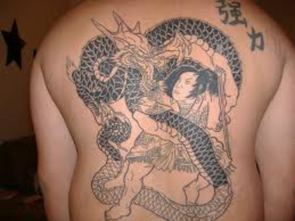 Tattoo red dragon on the leg