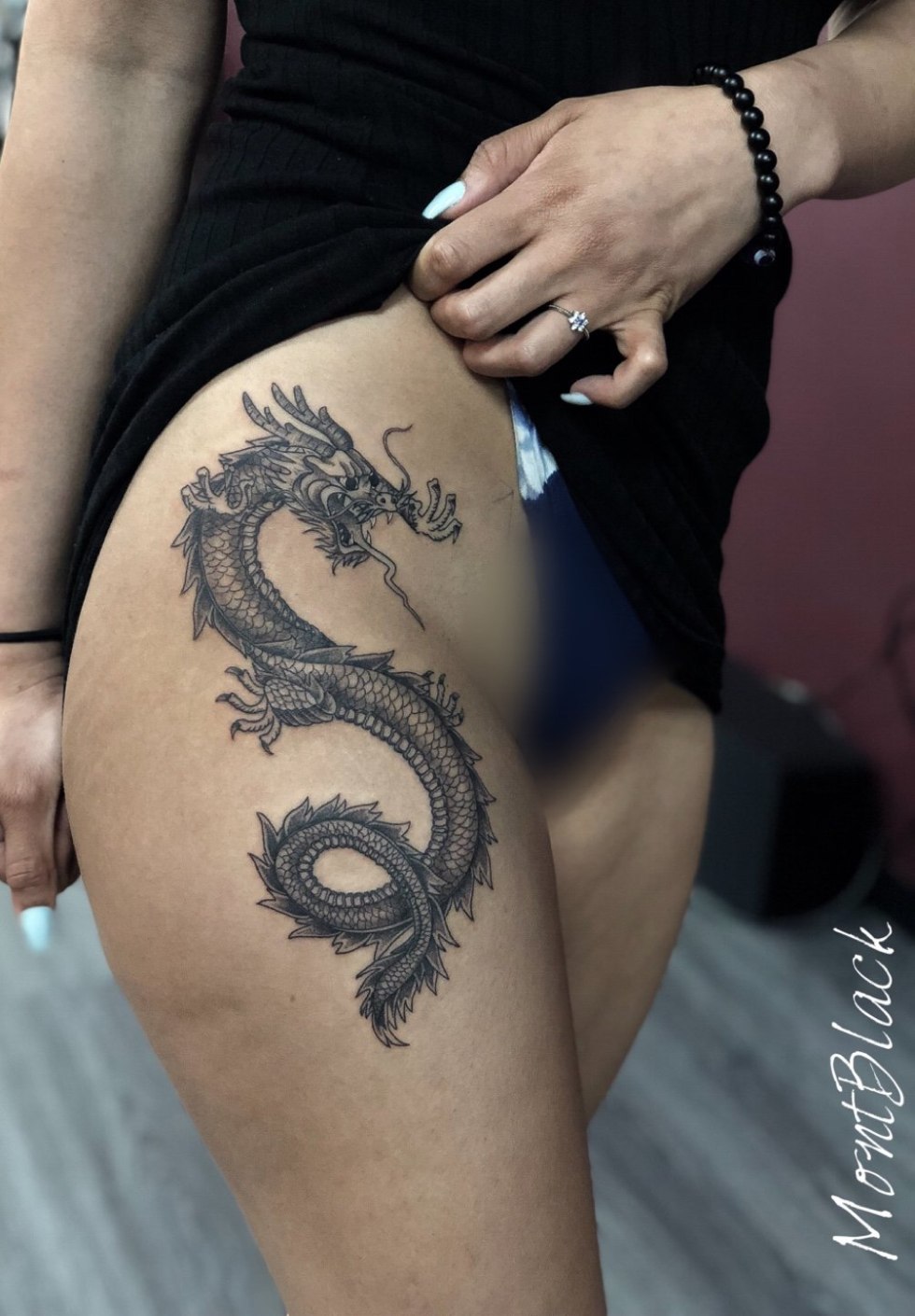 Dragon Tattoo on the thigh in the style of Traiber