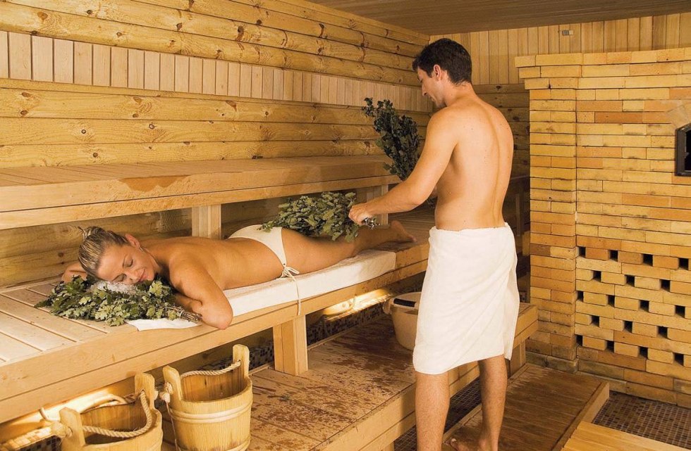 Massage with a broom in a steam room