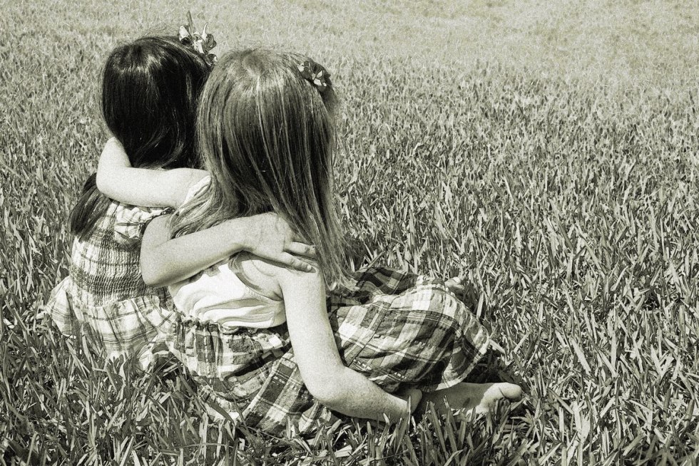 Three girls with raised hands