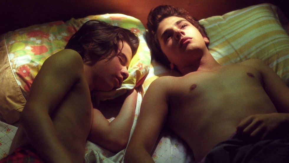 Two behind a laptop in bed naked