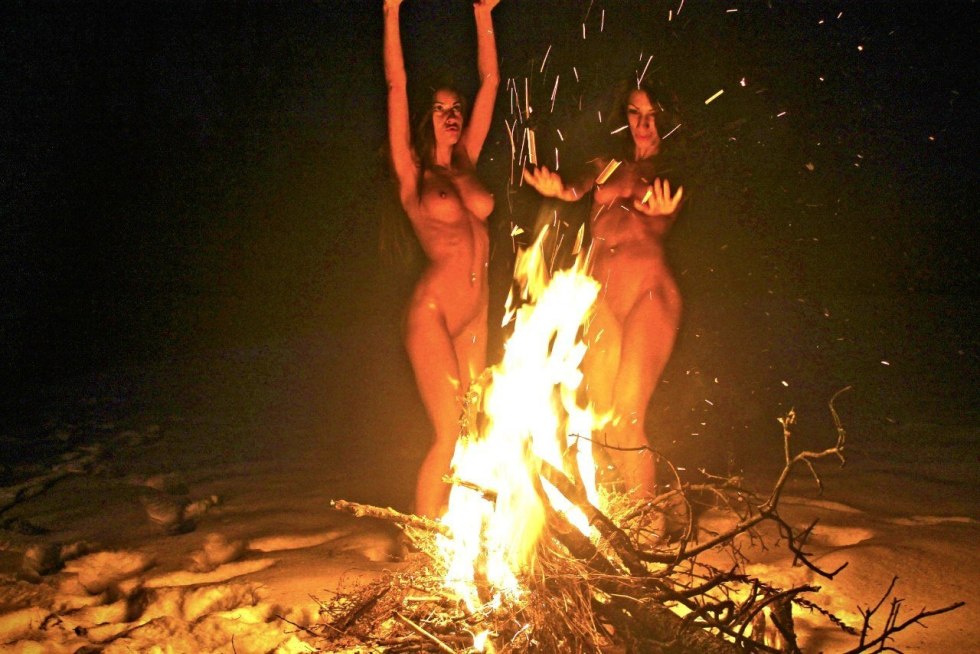 Naked woman near the fire