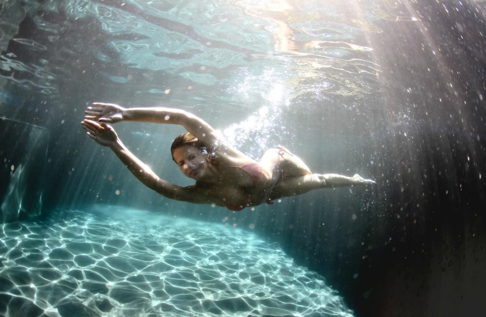 The girl is floating under water