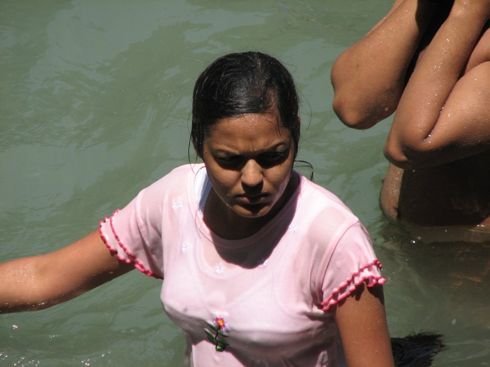 Naked women bathe in the river