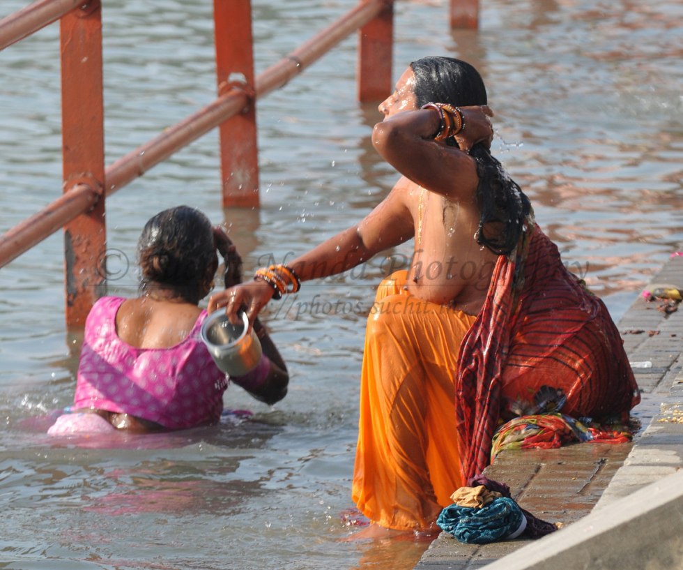 Indian women bathe
