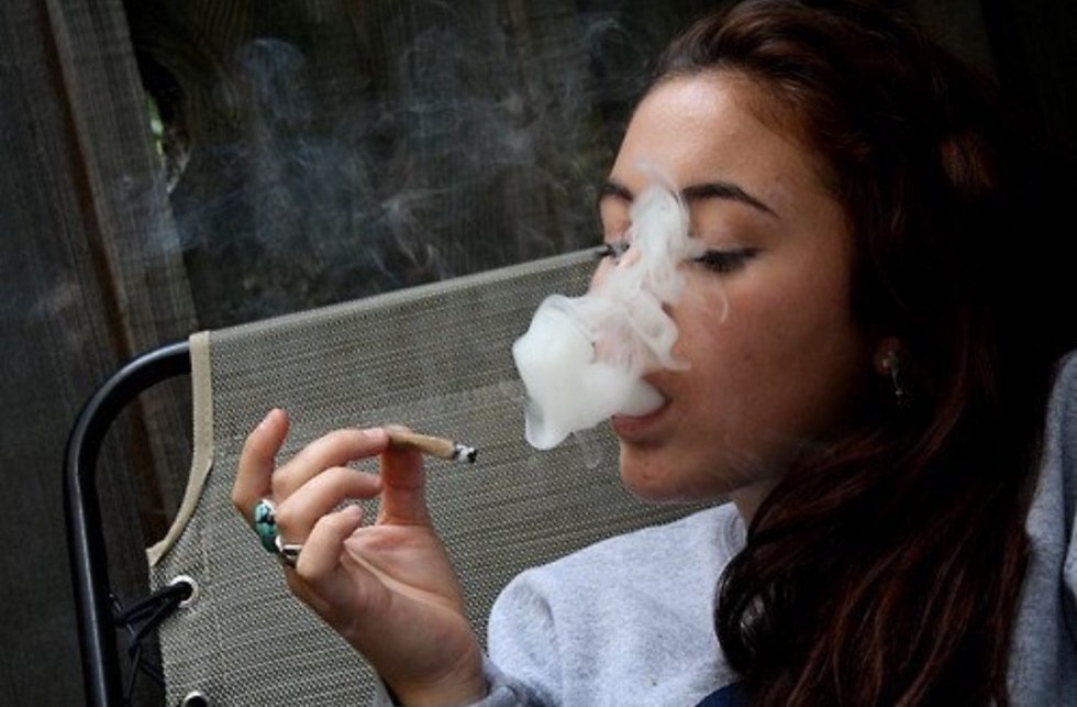 The girl smokes a jamb