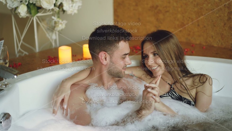 Guy and girl in a jacuzzi