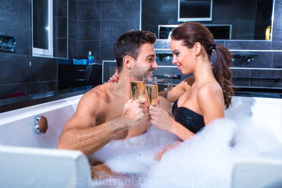 In the jacuzzi naked pair with drinking