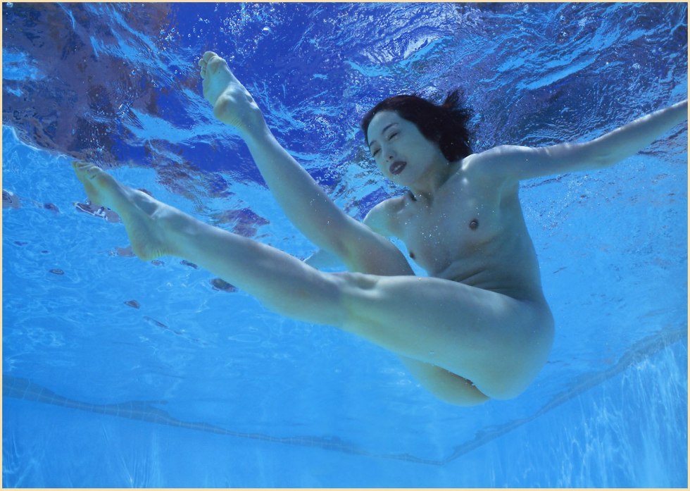 Naked women swim in the pool