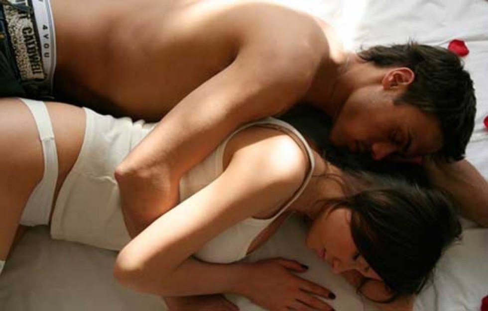 The guy hugs the girl behind the girl