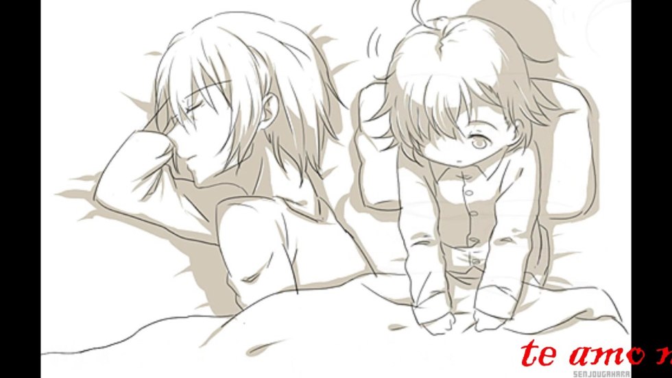 The couple lies in bed under the covers