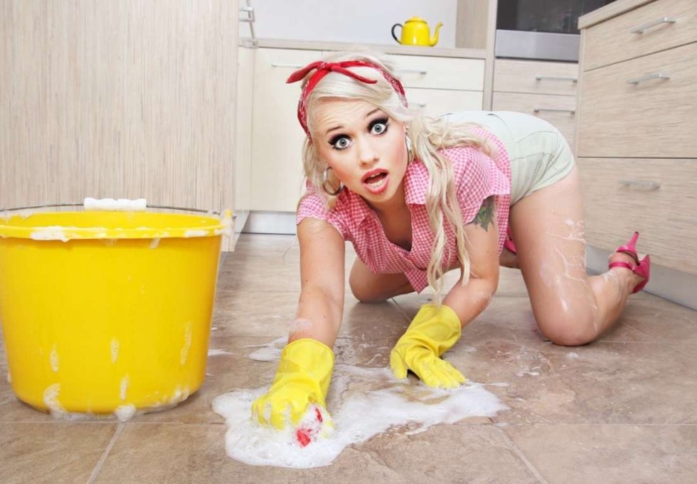 A naked woman is cleaning