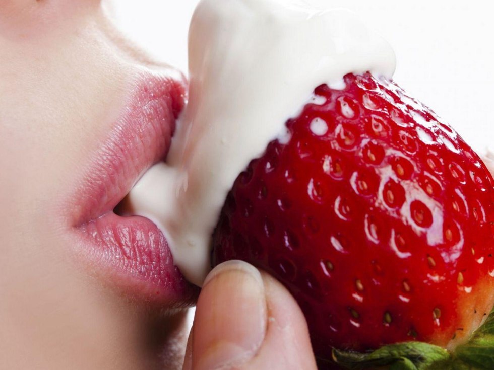 Strawberry on a naked woman