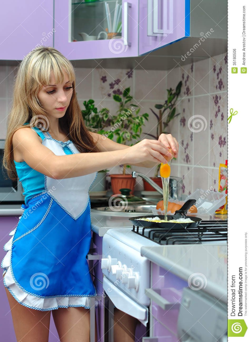Girl in a apron in the kitchen