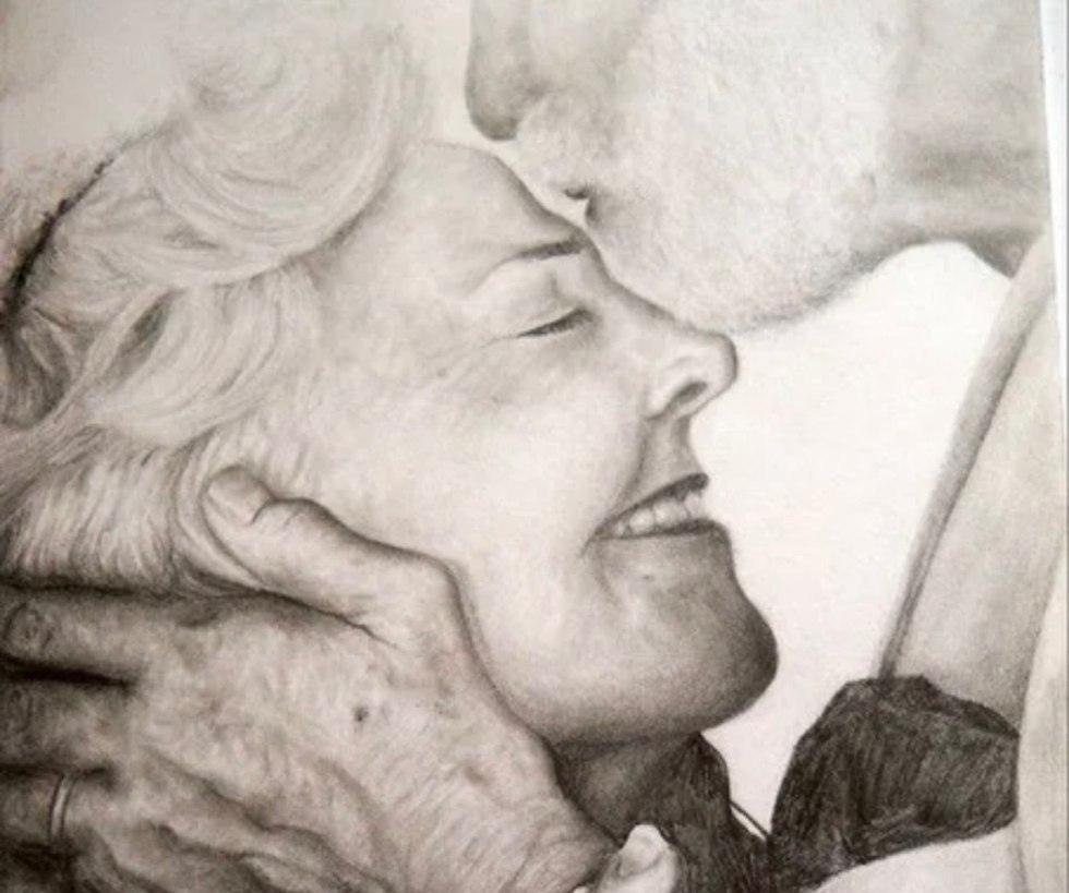 An elderly couple drawing