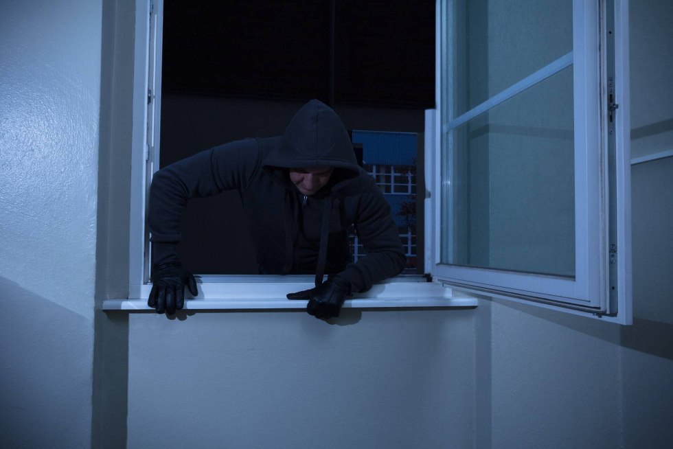 Thief through the window at night