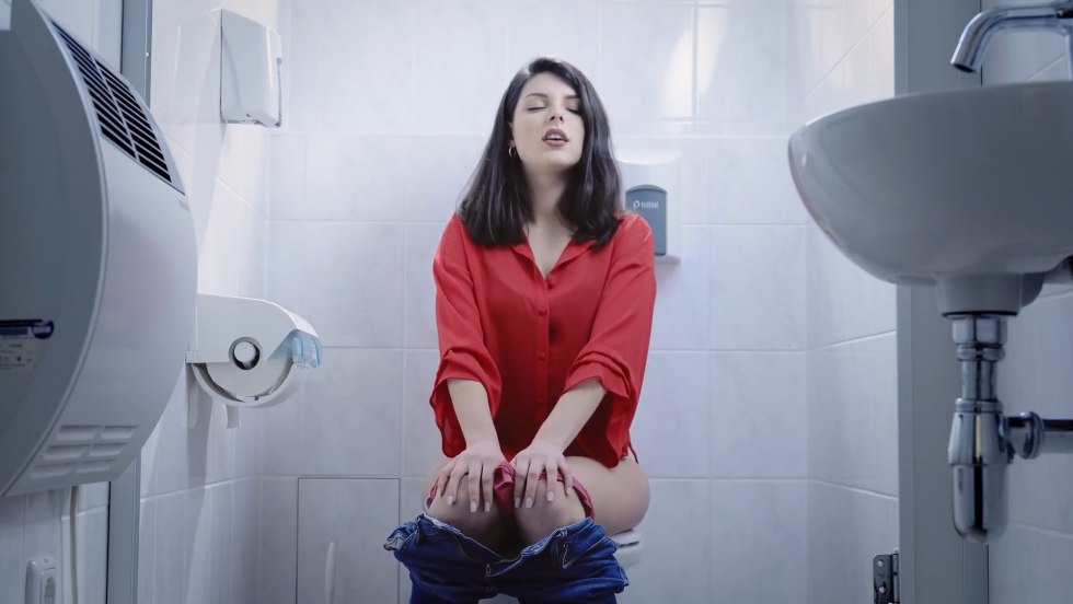 Woman sits on the toilet