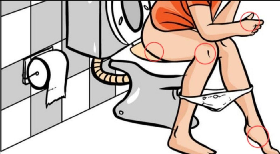 Through a hole in the wall of the toilet