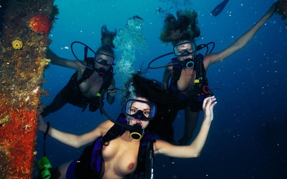 Naked swimmers underwater