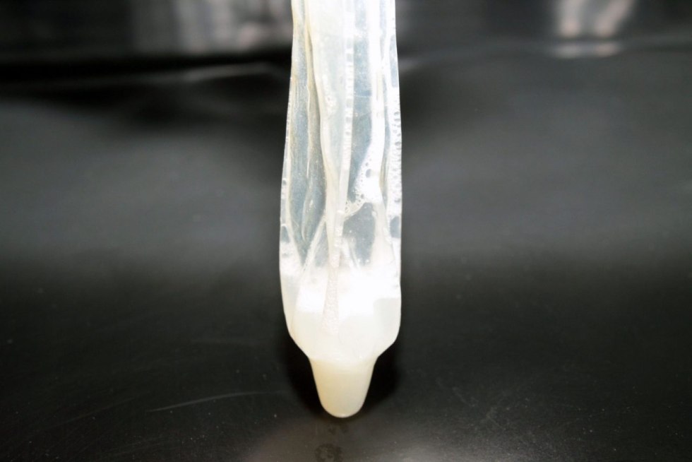 Girl with condom in her mouth