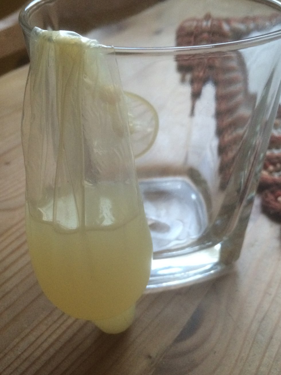 A huge cock cums in a condom