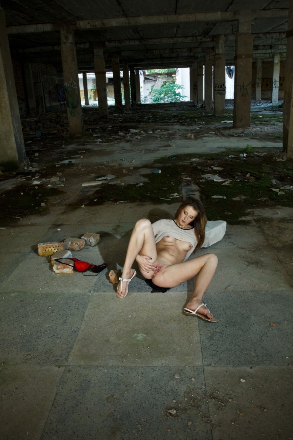Naked in stockings in an abandoned building