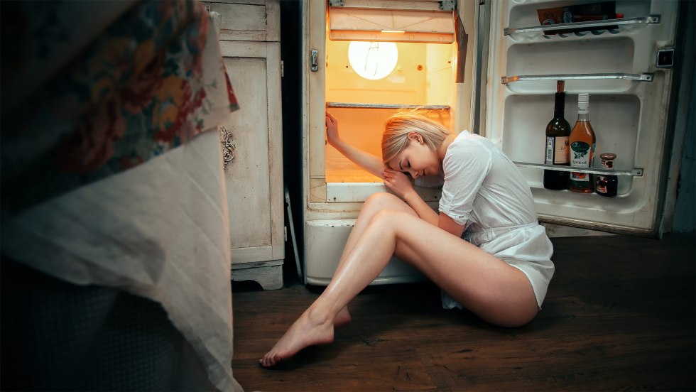 Naked woman at the refrigerator