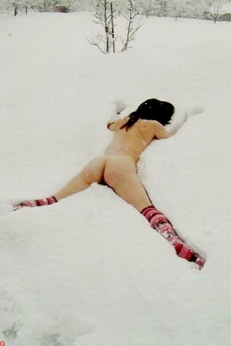 Beautiful woman lies naked in the snow priest
