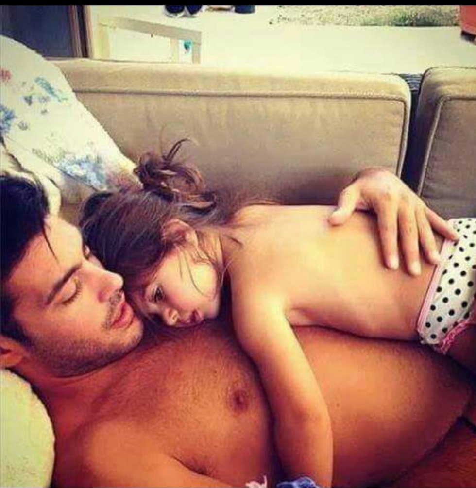 The girl is sleeping with dad