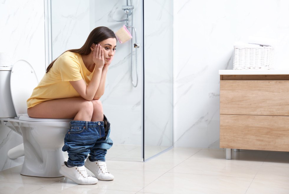 Woman sits in the toilet