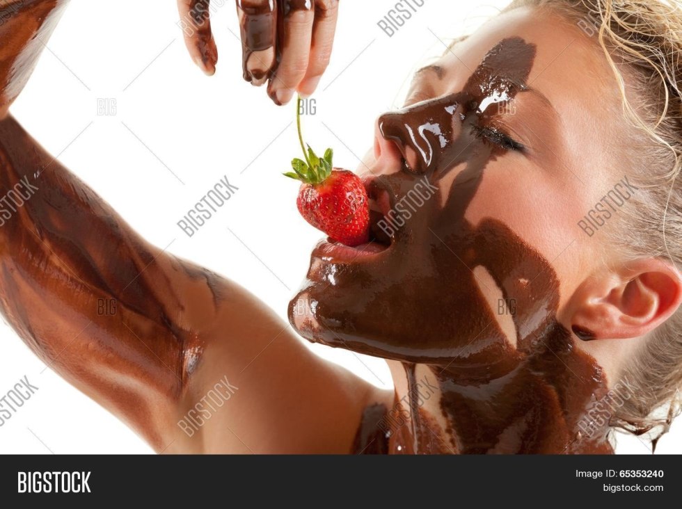 Girl with strawberry in chocolate