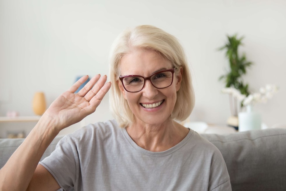 A 50 -year -old woman waves her hand