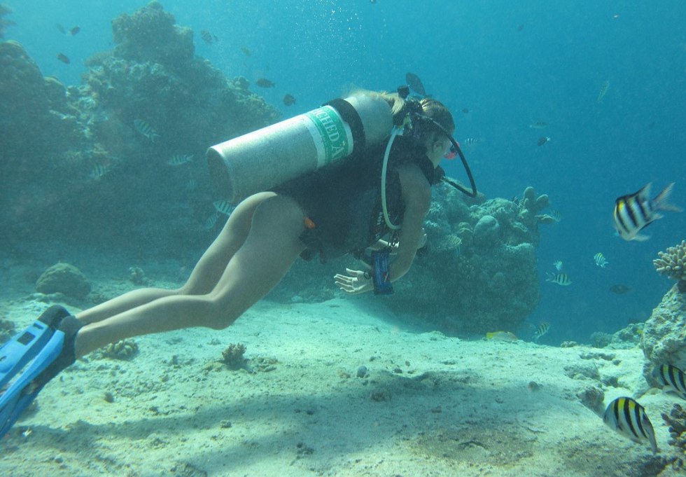 Naked women with flippers underwater