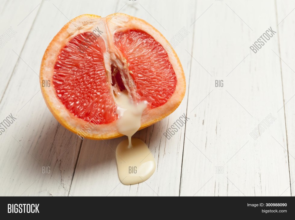 Grapefruit in section with fingers