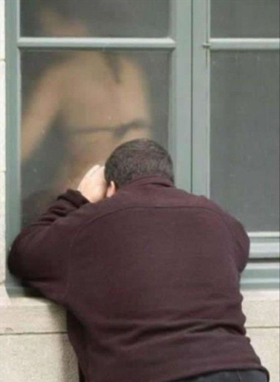 The guy peeps out the window