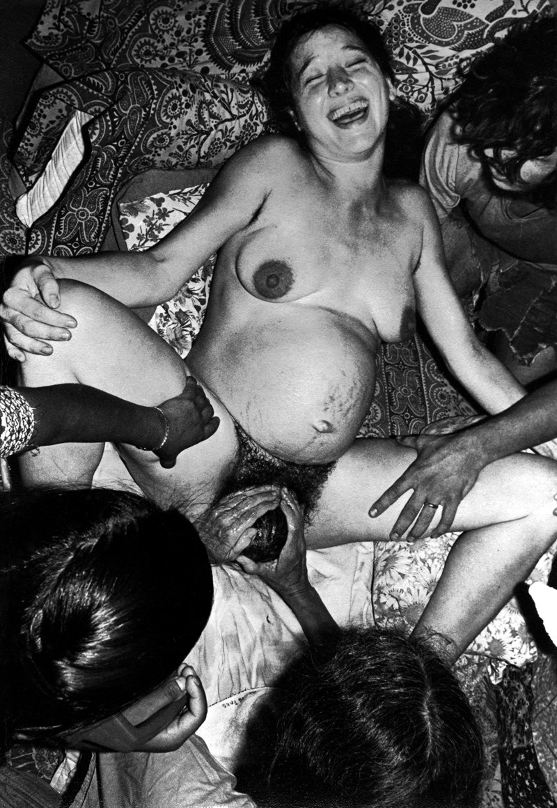 A naked pregnant woman gives birth