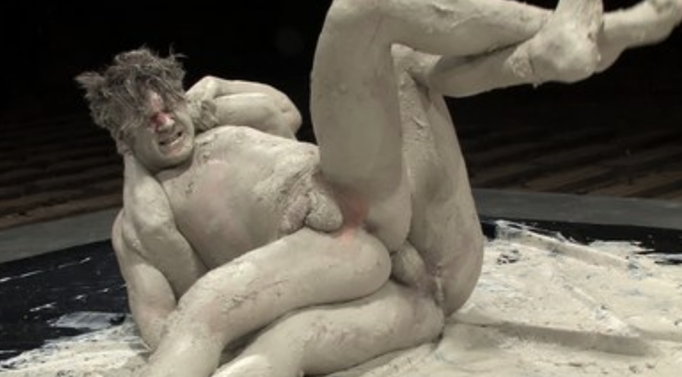 Erotic struggle of men in mud