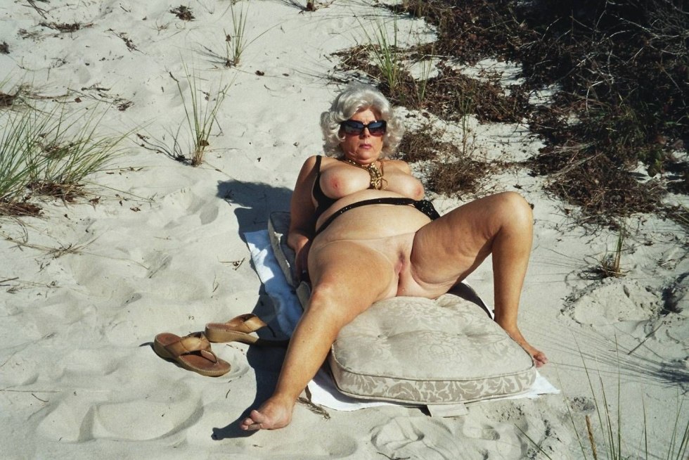 The old women on the beach spread their legs