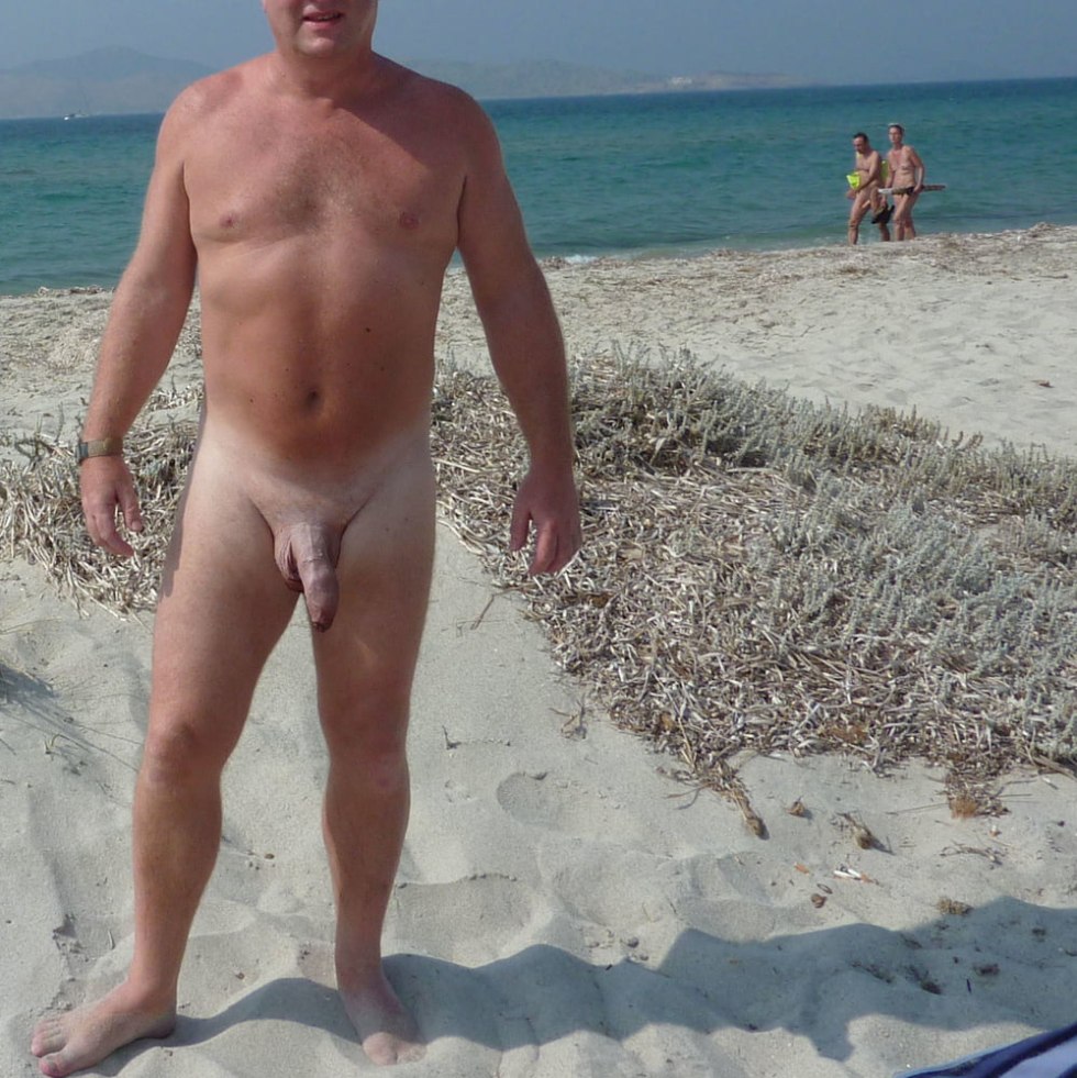 Naked mature men on the beach of the river