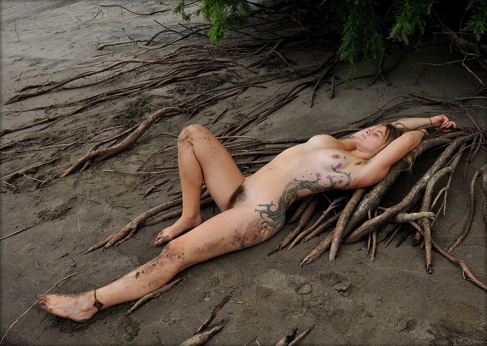 Naked women associated in mud
