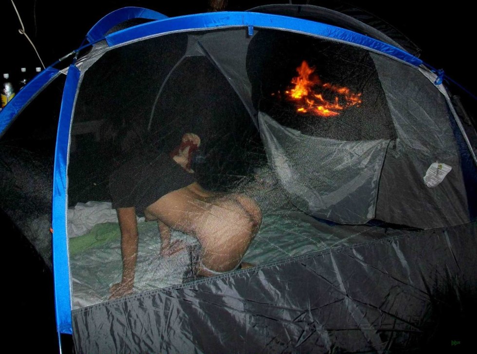 Naked breasts at night in a tent