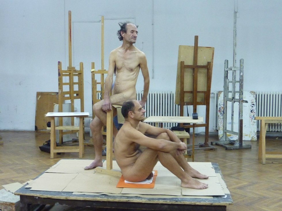 Naked guys pose an artist