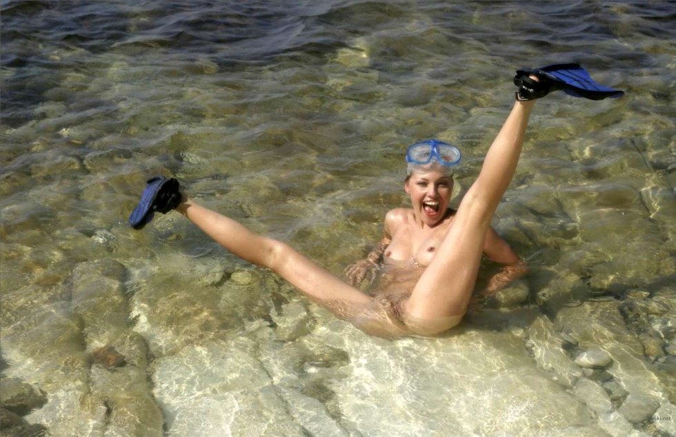 Naked women with flippers underwater