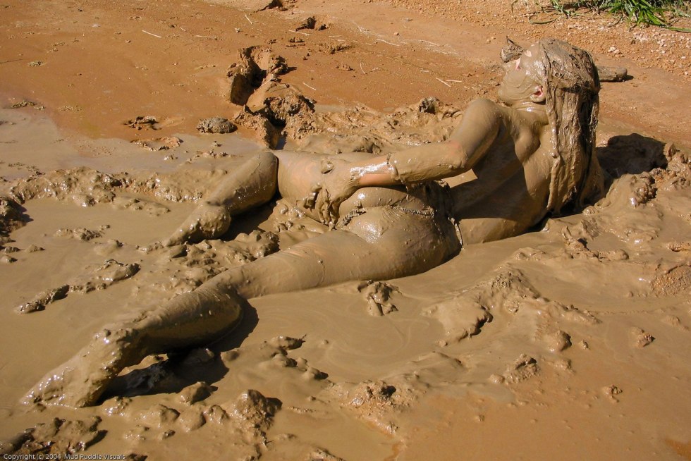 Naked women bathe in mud