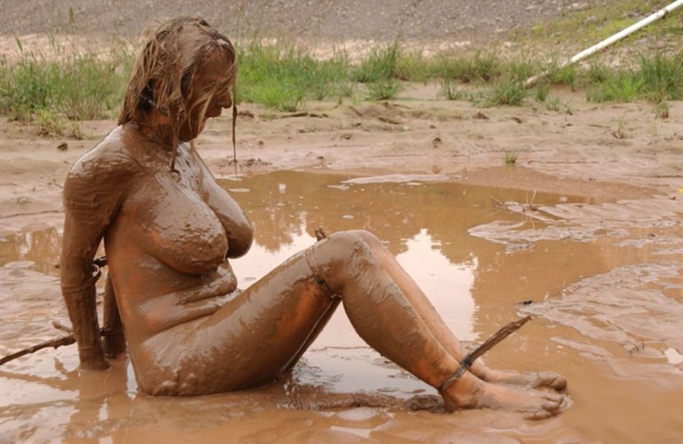 Naked women bathe in mud