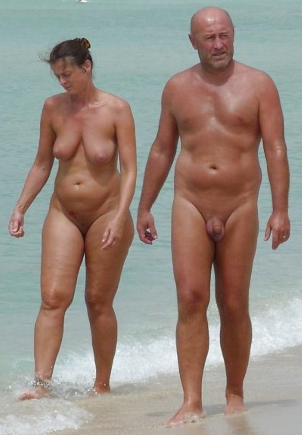 Naked men and women on the beach