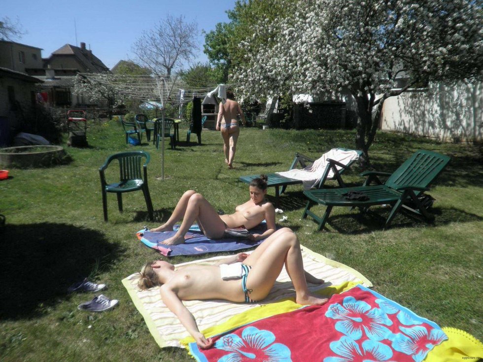 Wife sunbathes topless in the country